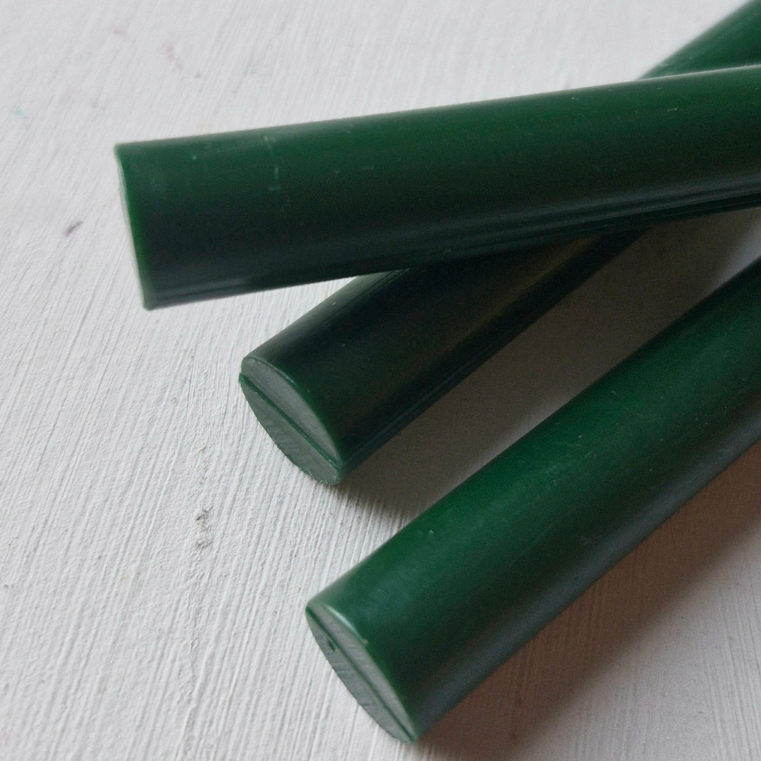 Handmade British Racing Green sealing wax sticks, 11mm diameter, displayed on a white surface. Perfect for crafts and letter sealing.