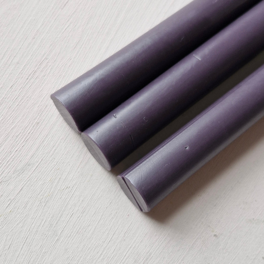 Close-up of three plum-colored 11mm sealing wax sticks from a 10-pack, ideal for office and crafting use.