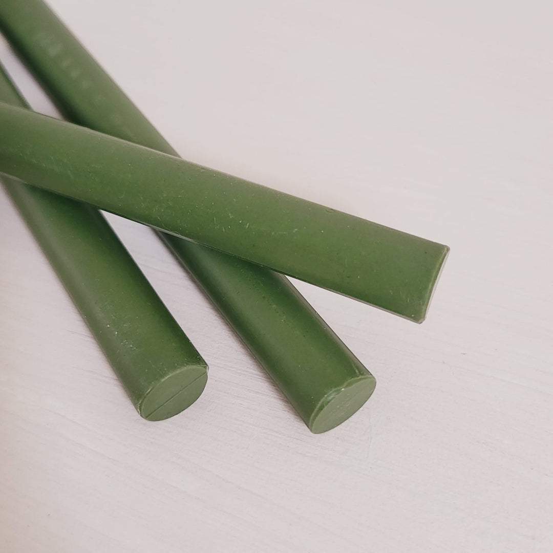 Close-up of olive green 11mm sealing wax sticks from a 10-pack, ideal for crafting and office sealing tasks.