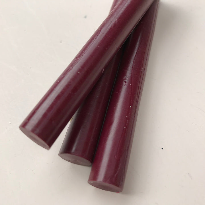 Close-up of burgundy sealing wax sticks from a 10-pack, 11mm diameter, ideal for office and crafting use.